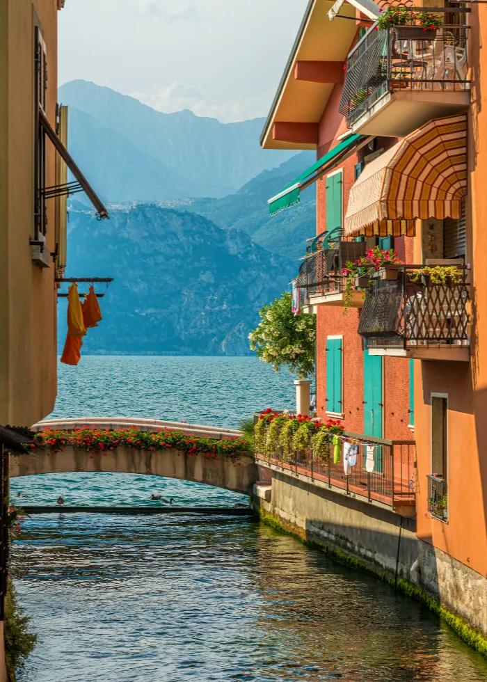 Luxury apartments and lake-view villas in Malcesine with mountain backdrop.